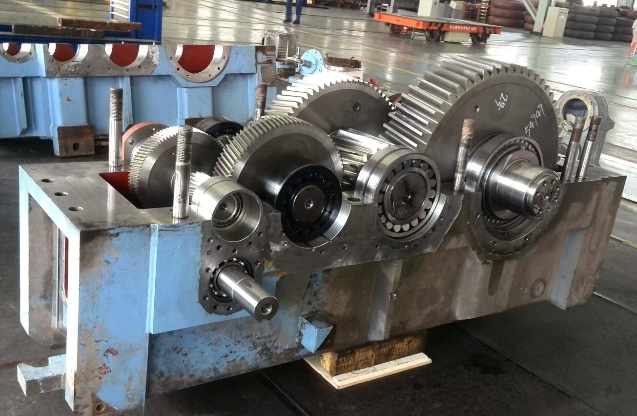 How does material selection impact the overall efficiency of a gearbox?